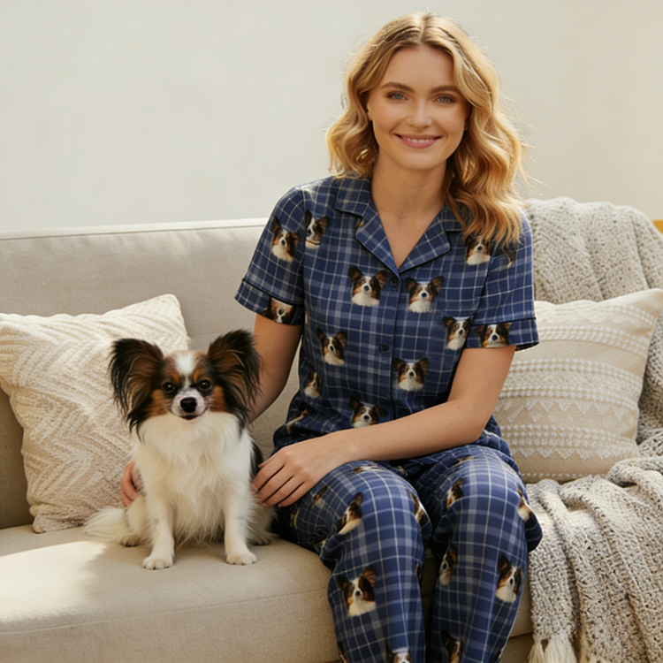 Woman in pajamas holding a small dog on a swing set with plants and flowers around.